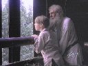 In a barn Indy and Tolstoy watch the soldiers go by.